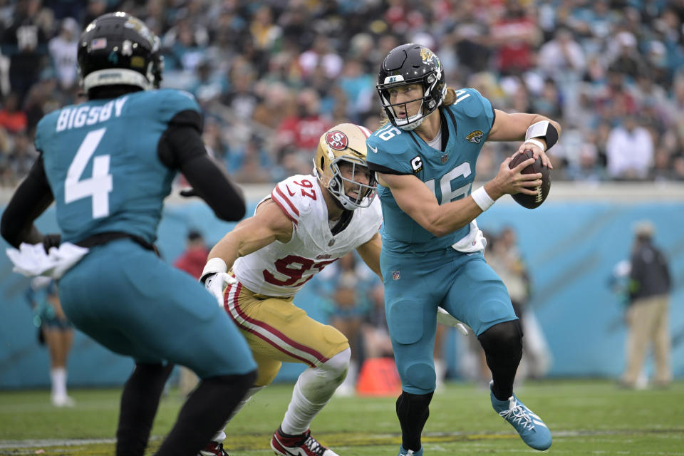 San Francisco 49ers defensive end Nick Bosa (97) pressures Jacksonville Jaguars quarterback Trevor Lawrence, right, during the second half of an NFL football game, Sunday, Nov. 12, 2023, in Jacksonville, Fla. Lawrence went on to throw an interception on the play. (AP Photo/Phelan M. Ebenhack)