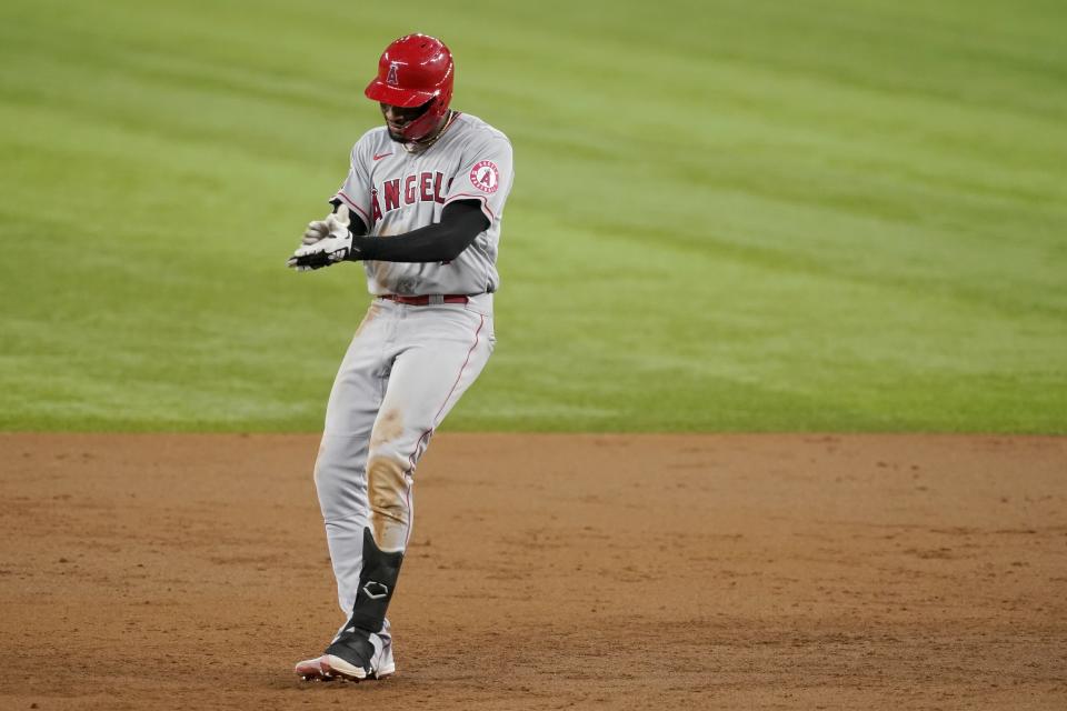 Los Angeles Angels' Jo Adell celebrates his two-RBI double in the third inning of the team's baseball game against the Texas Rangers in Arlington, Texas, Tuesday, Aug. 3, 2021. (AP Photo/Tony Gutierrez)