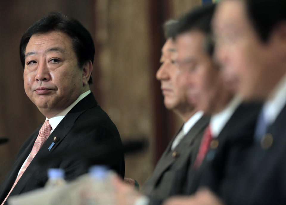 Japanese Prime Minister Yoshihiko Noda glances at Democratic Party presidential candidates during a debate at the Japan National Press Club in Tokyo Wednesday, Sept. 12, 2012. (AP Photo/Itsuo Inouye)