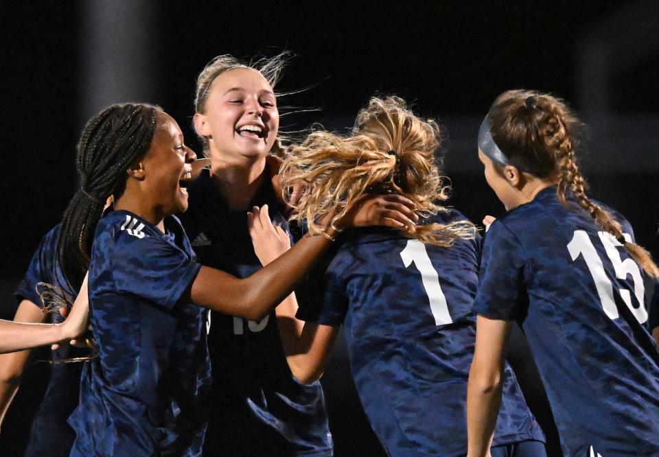 Twinsburg senior Olivia Zelenka is mobbed by teammates after scoring her team's first goal during the second half of a soccer game against Nordonia, Wednesday, Sept. 7, 2022, in Twinsburg, Ohio.