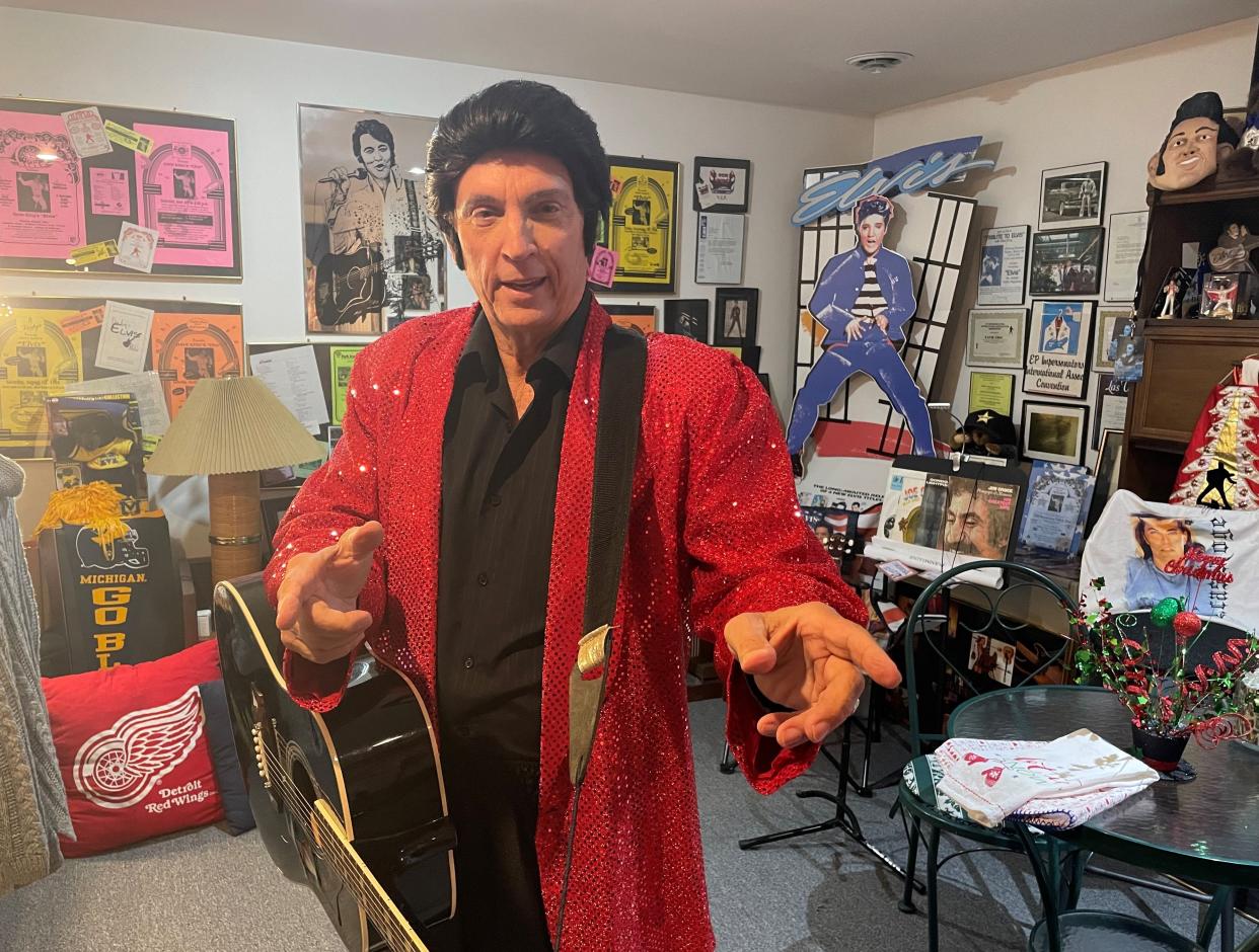 Elvis Presley tribute artist Dave "King" Falzetti strikes an Elvis pose, surrounded by memorabilia from his nearly 49-year career, at his home in Genoa Township near Brighton, Tuesday, Dec. 20, 2022. Falzetti is going for a Guinness World Record.