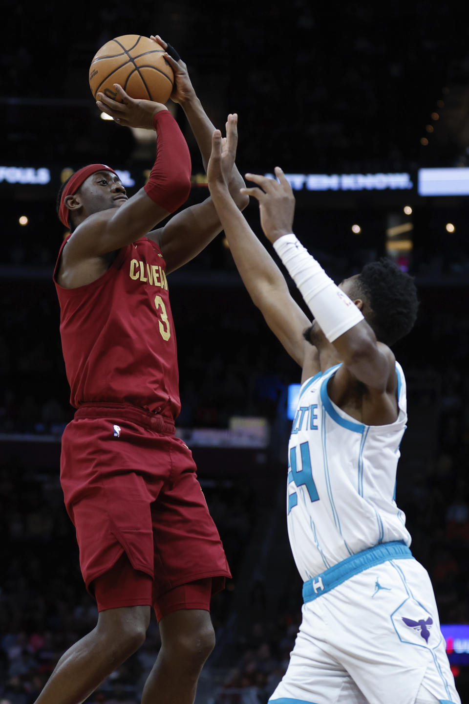Cleveland Cavaliers guard Caris LeVert (3) shoots against Charlotte Hornets forward Brandon Miller (24) during the first half of an NBA basketball game, Monday, March 25, 2024, in Cleveland. (AP Photo/Ron Schwane)