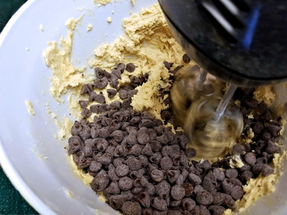 Chocolate chip cookie dough in a mixer