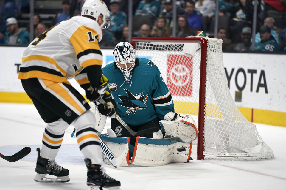 San Jose Sharks goaltender Martin Jones (31) defends on a shot from Pittsburgh Penguins left wing Tanner Pearson (14) during the second period of an NHL hockey game in San Jose, Calif., Tuesday, Jan. 15, 2019. (AP Photo/Tony Avelar)