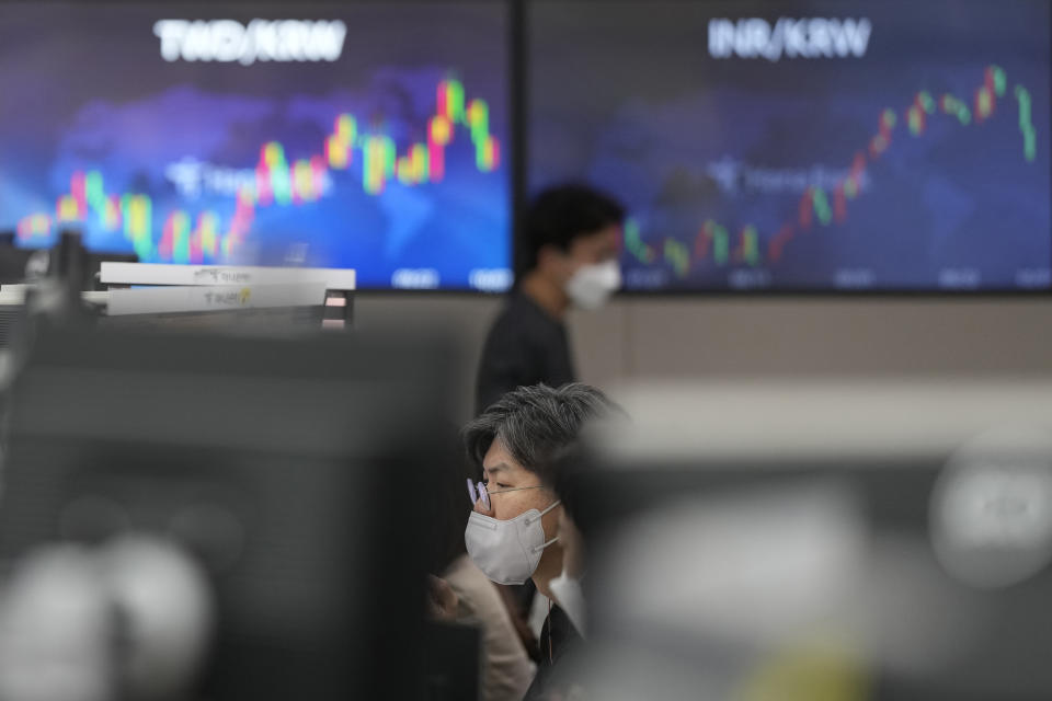 A currency trader watches computer monitors at a foreign exchange dealing room in Seoul, South Korea, Friday, Oct. 7, 2022. Asian shares followed Wall Street lower Friday ahead of U.S. jobs data investors hope will persuade the Federal Reserve to ease off plans for more interest rate hikes. (AP Photo/Lee Jin-man)