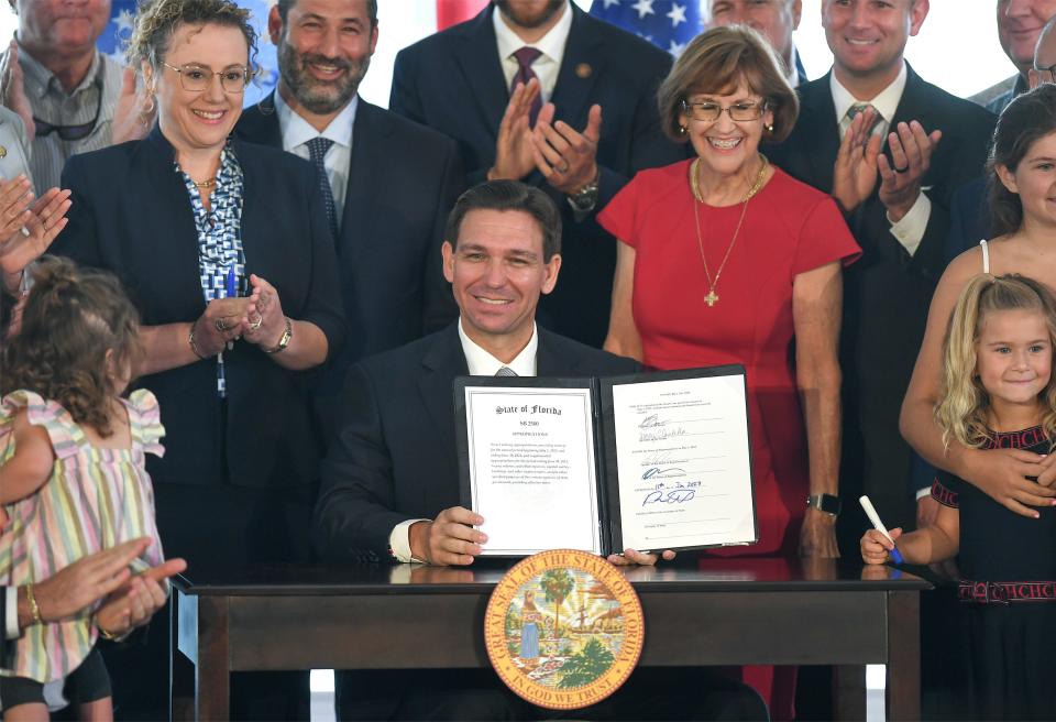 Florida Governor Ron DeSantis displays his signature for the Florida budget after speaking at the Pelican Yacht Club on Thursday June 15, 2023, in Fort Pierce.