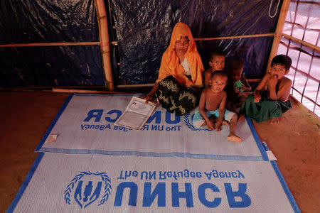 Roshid Jan, a Rohingya refugee who said she is not sure about her age, sits with her children at their shelter at the camp for widows and orphans inside the Balukhali camp near Cox's Bazar, Bangladesh, December 5, 2017. REUTERS/Damir Sagolj