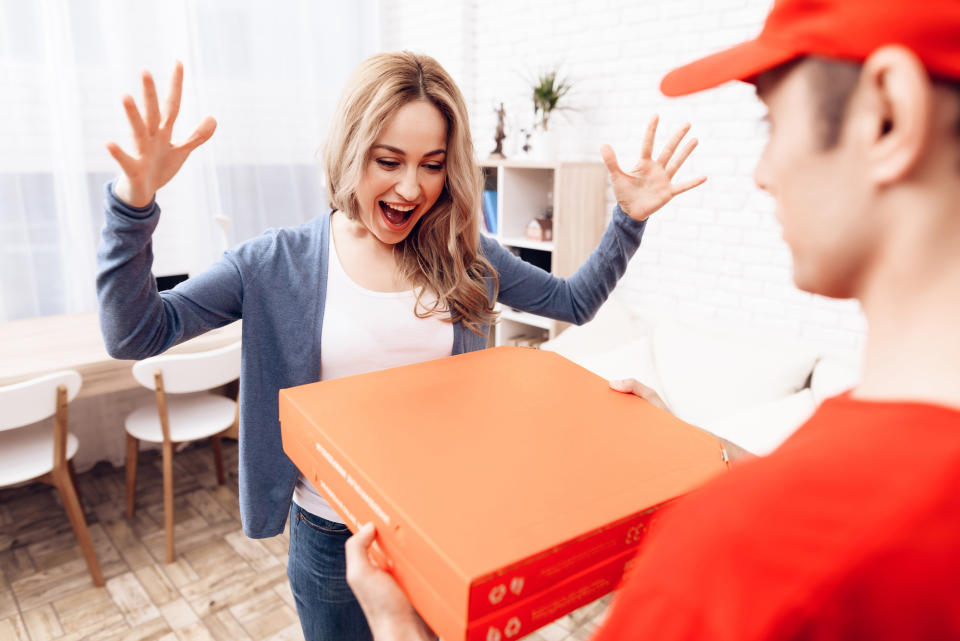 Man delivering pizzas to woman