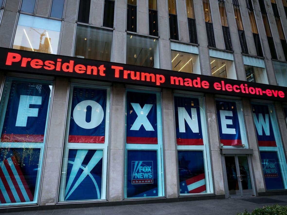 A headline about then-president Donald Trump is displayed outside Fox News studios in New York on Nov. 28, 2018. Fox Corp. chairman Rupert Murdoch acknowledged in a deposition that some Fox News commentators endorsed the false allegations by Trump and his allies that the 2020 presidential election was stolen and that he did not step in to stop them from promoting the claims.   (Mark Lennihan/The Associated Press - image credit)