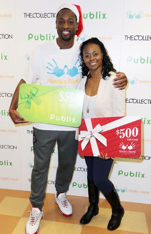 <p>Alexander Tamargo/WireImage</p> Dwyane Wade and Tragil Wade attend Publix Supermarket where Wade's World Foundation granted the wishes of deserving families on December 22, 2013.