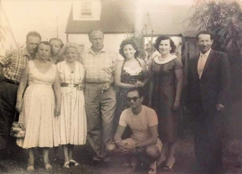 Oskar Schindler, center, at Rena and Lewis Fagen's Long Island home in 1957. Rena's mother is directly to his right (fourth from left) and Rena is directly to his left (third from right), with Lewis kneeling.