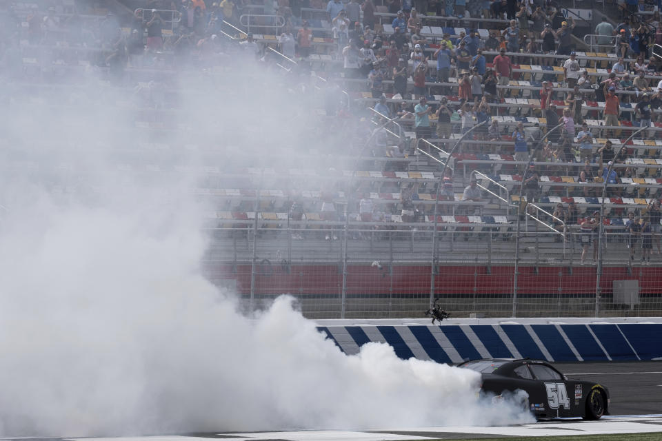Ty Gibbs does a celebratory burnout after winning the Alsco Uniforms 300 NASCAR Xfinity Series auto race at Charlotte Motor Speedway on Saturday, May 29, 2021 in Charlotte, NC. (AP Photo/Ben Gray)