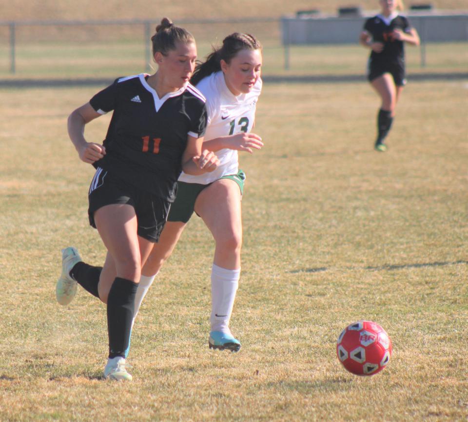 Cheboygan freshman striker Jaelyn Wheelock (11) heads for goal while Clare's Olivia Marshall (13) chases during the second half of a varsity girls soccer matchup in Cheboygan on Friday. Wheelock scored two goals in a 3-0 Cheboygan victory.