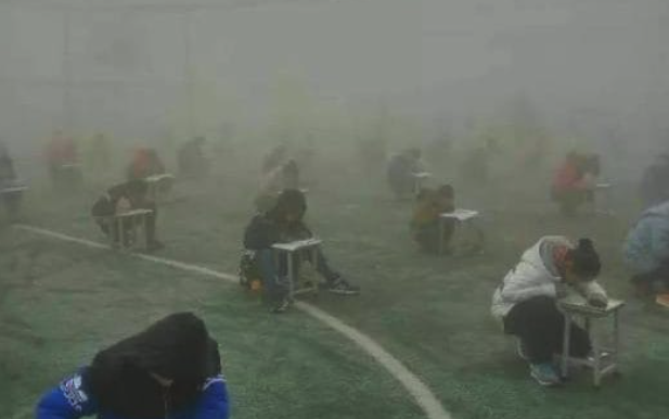 The students were seen desperately attempting to read their papers (Picture: Dahe News)