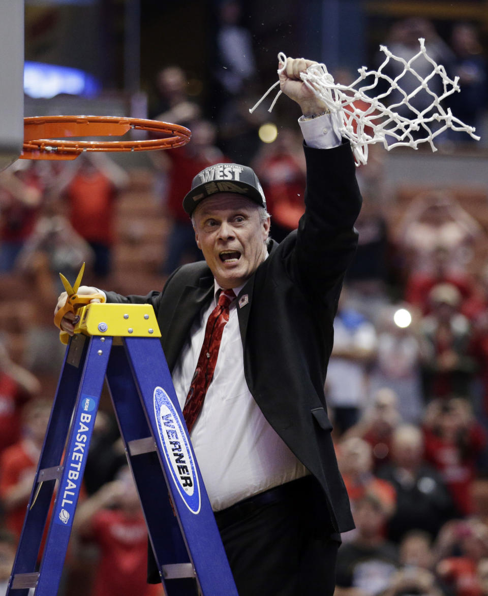 Wisconsin head coach Bo Ryan celebrates after cutting down the net after a regional final NCAA college basketball tournament game against Arizona, Saturday, March 29, 2014, in Anaheim, Calif. Wisconsin won 64-63 in overtime. (AP Photo/Jae C. Hong)