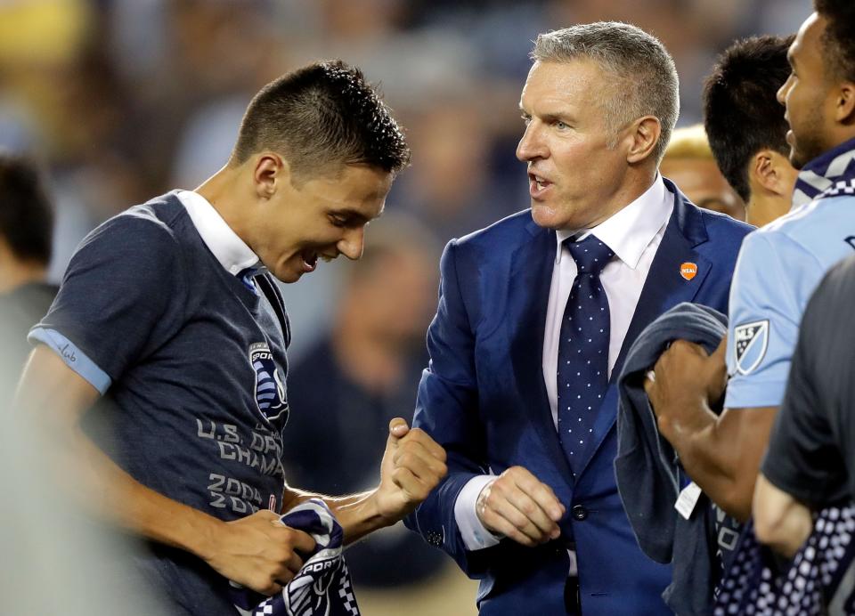 Head coach Peter Vermes congratulates Daniel Salloi after Sporting Kansas City defeated the New York Red Bulls 2-1 to win the 2017 U.S. Open Cup on Sept. 20, 2017 in Kansas City, Kansas. (Jamie Squire/Getty Images)