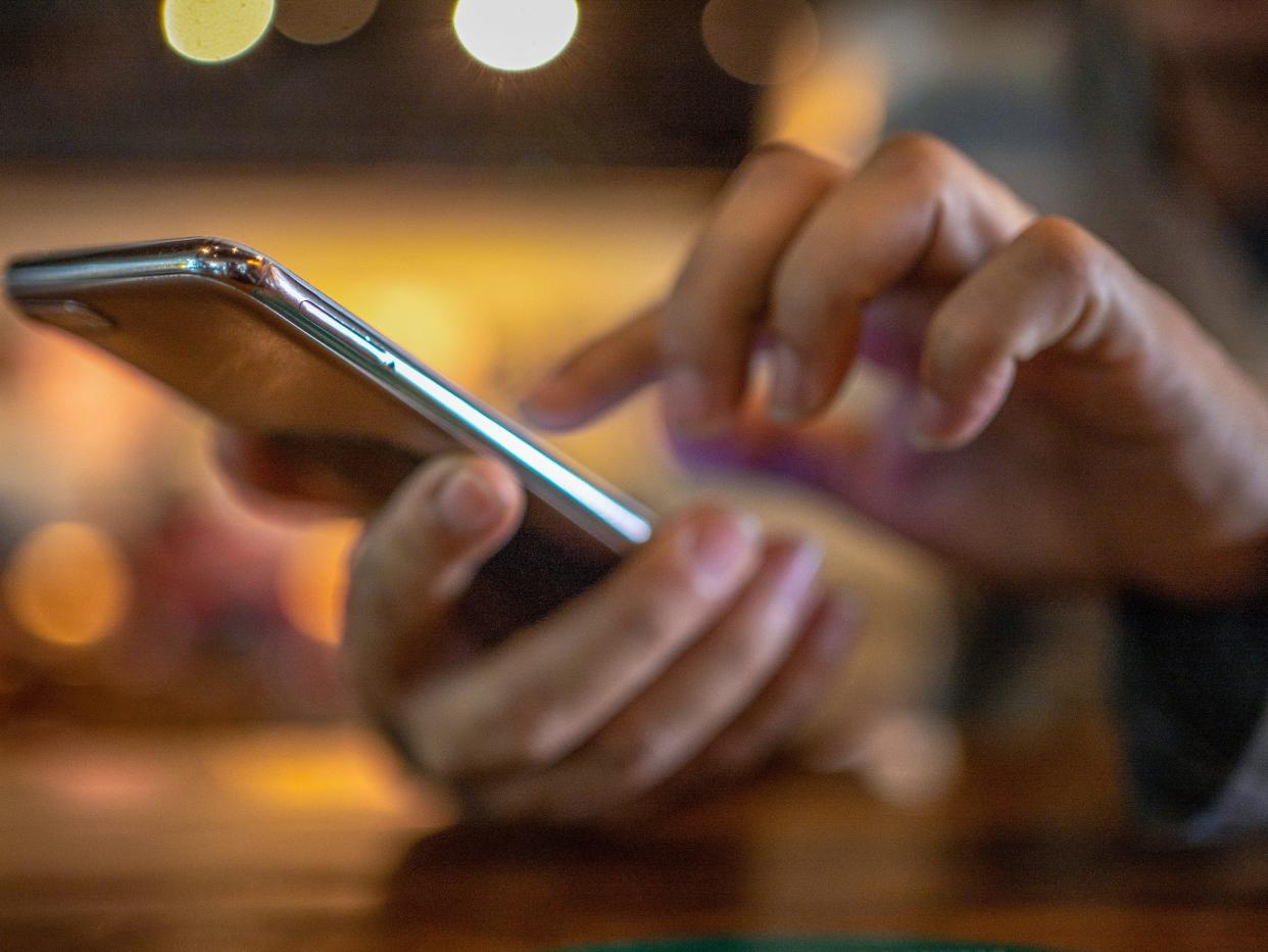 close-up of hands holding a cell phone