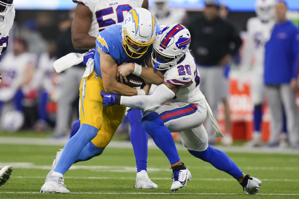 Los Angeles Chargers quarterback Easton Stick (2) is tackled by Buffalo Bills safety Taylor Rapp (20) during the second half of an NFL football game Saturday, Dec. 23, 2023, in Inglewood, Calif. (AP Photo/Ryan Sun)