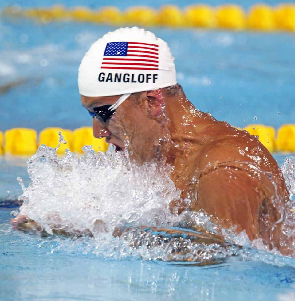 U.S swimmer Mark Gangloff competes in a heat of the 100-meter breaststroke at the 2004 Olympic Games on Aug. 14, 2004, in Athens, Greece. Gangloff, a 2000 Firestone graduate, won four Division I state championships and two Olympic gold medals.
