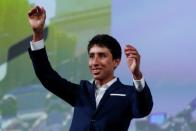 Cyclist Egan Bernal of Colombia reacts on stage during a news conference to unveil the itinerary of the 2020 Tour de France cycling race in Paris