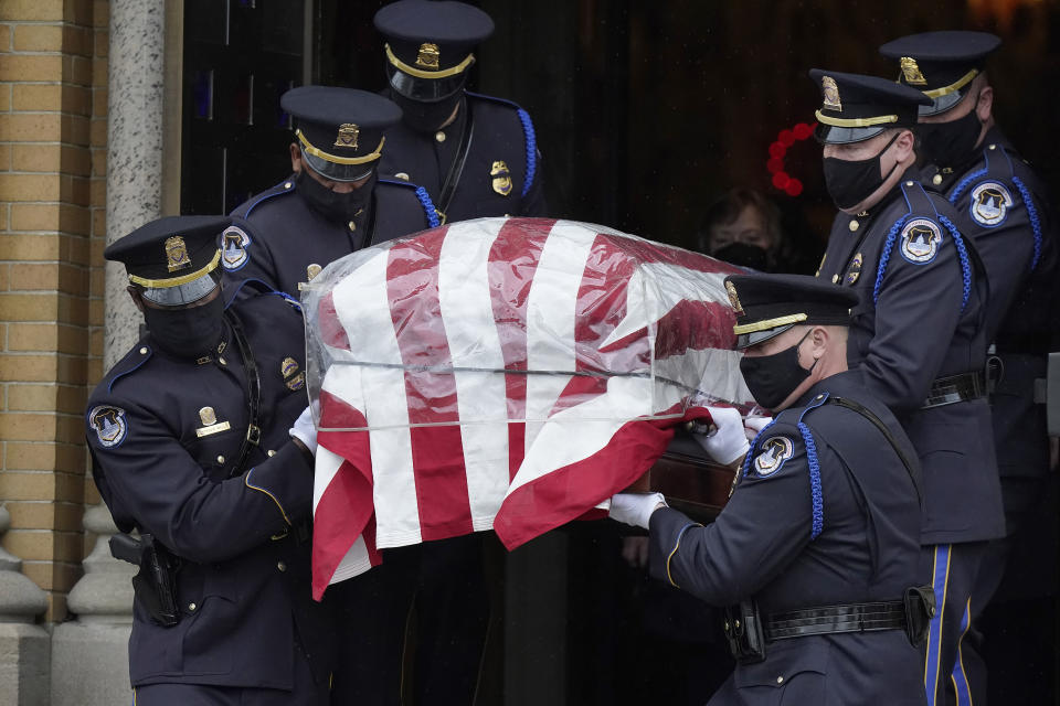 Pallbearers from the U.S. Capitol Police carry the casket of William "Billy" Evans from St. Stanislaus Kostka Church following a funeral Mass, Thursday, April 15, 2021, in Adams, Mass. Evans, a member of the U.S. Capitol Police, was killed on Friday, April 2, when a driver slammed his car into a checkpoint he was guarding at the Capitol. (AP Photo/Steven Senne)
