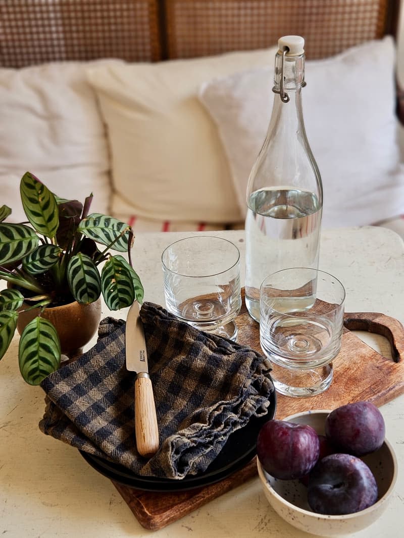 Glass wear and fruits sit on coffee table