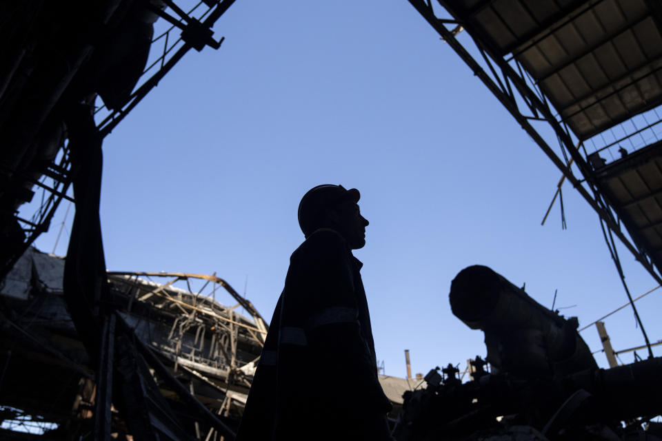 Workers remove debris from the roof of a damaged DTEK thermal power plant after a Russian attack in Ukraine, Thursday, May 2, 2024. Ukrainian energy workers are struggling to repair the damage from intensifying airstrikes aimed at pulverizing Ukraine's energy grid, hobbling the economy and sapping the public's morale. (AP Photo/Francisco Seco)