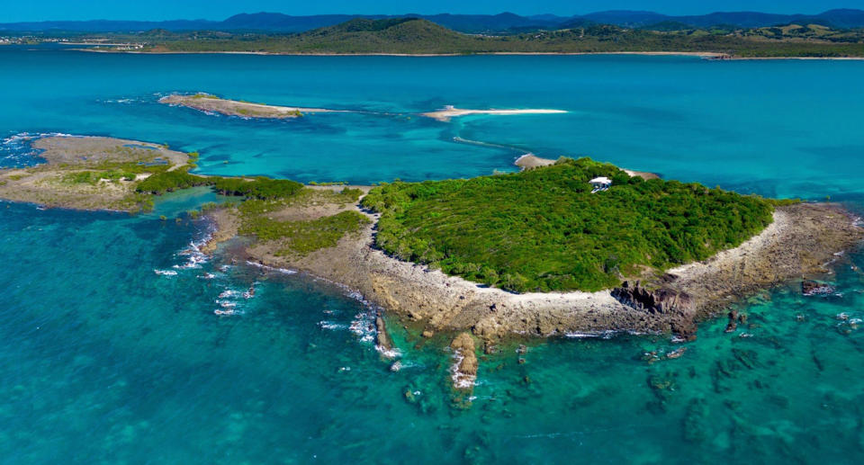 Tropical Victor Island surrounded by blue ocean water. 