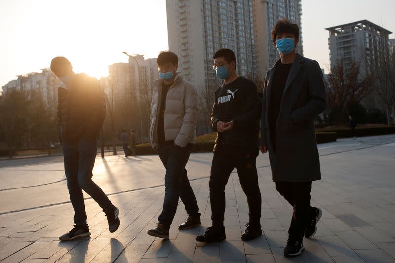 People wears a face mask an office complex in Beijing as the country is hit by an outbreak of the novel coronavirus