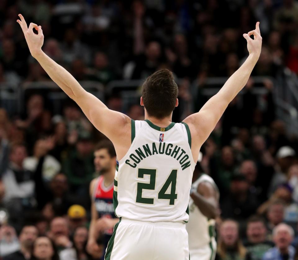 Milwaukee Bucks guard Pat Connaughton celebrates a three-point basket during the first half of the team's game against the Washington Wizards on March 24 at Fiserv Forum.