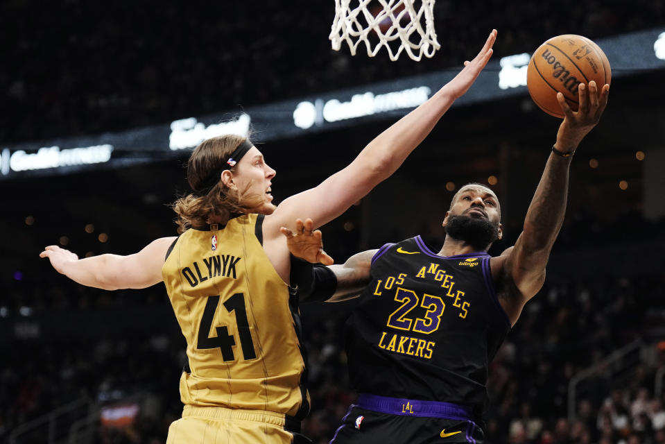 Los Angeles Lakers forward LeBron James (23) shoots around Toronto Raptors forward Kelly Olynyk (41) during the second half of an NBA basketball game Tuesday, April 2, 2024, in Toronto. (Frank Gunn/The Canadian Press via AP)