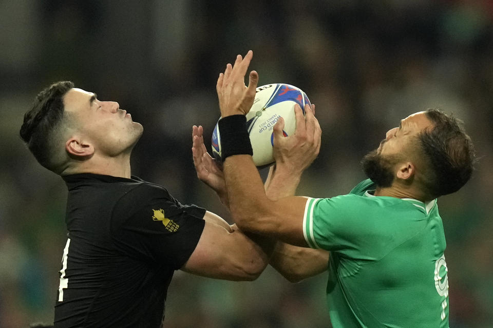 New Zealand's Will Jordan and Ireland's Jamison Gibson-Park, right, battle for the ball during the Rugby World Cup quarterfinal match between Ireland and New Zealand at the Stade de France in Saint-Denis, near Paris Saturday, Oct. 14, 2023. (AP Photo/Thibault Camus)