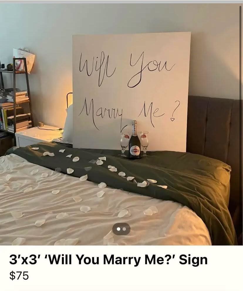 "Will you marry me?" sign on a bed with petals, for sale for $75