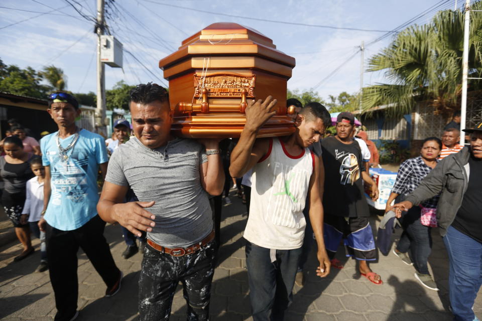 FILE - In this May 3, 2018 file photo, mourners, friends and family members carry the casket with the body of Nelson Tellez, who died of gunshot wounds during the April 20 protests against the government of President Daniel Ortega, in Ciudad Sandino, Nicaragua. Nicaragua's President Ortega and his wife, Vice President Rosario Murillo, maintained the use of force was justified to fend off an attempted coup. Domestic and international human rights groups strongly disagreed. (AP Photo/Alfredo Zuniga, File)