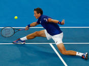 Proving his flexibility, Vasek Pospisil stretches for a forehand out wide.