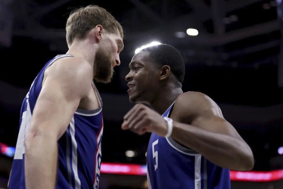 Sacramento Kings guard De'Aaron Fox (right) celebrates with forward Domantas Sabonis during the second half of the team's NBA basketball game against the Denver Nuggets in Sacramento on Dec. 2, 2023.