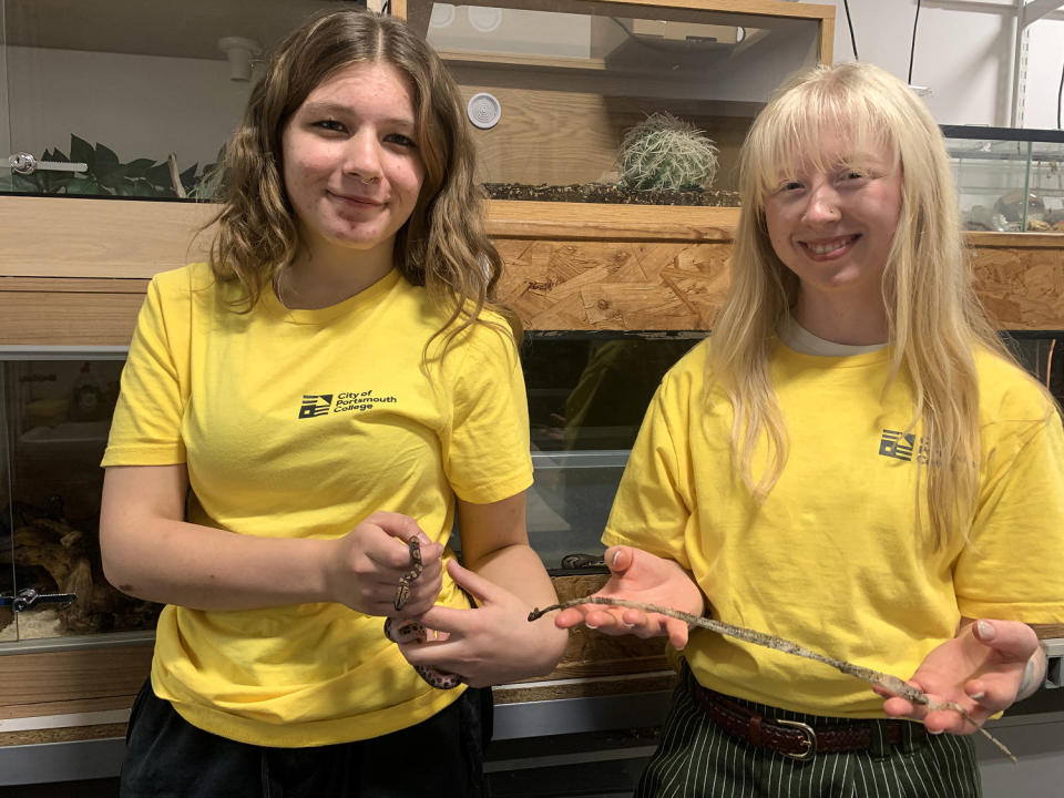 Evie Allen, Level 2 student, and Ashleigh Nicole, Teaching Assistant, hold one of the baby snakes and a snakeskin. (City of Portsmouth College)