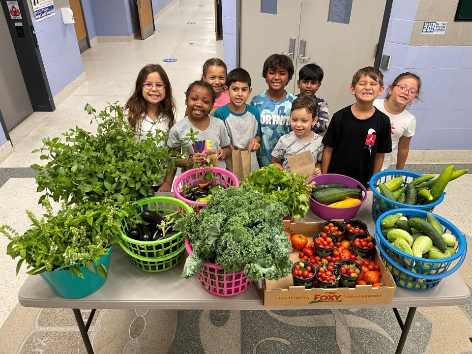 George L. Catrambone Elementary School  students in Long Branch stand next to their farmer's market.