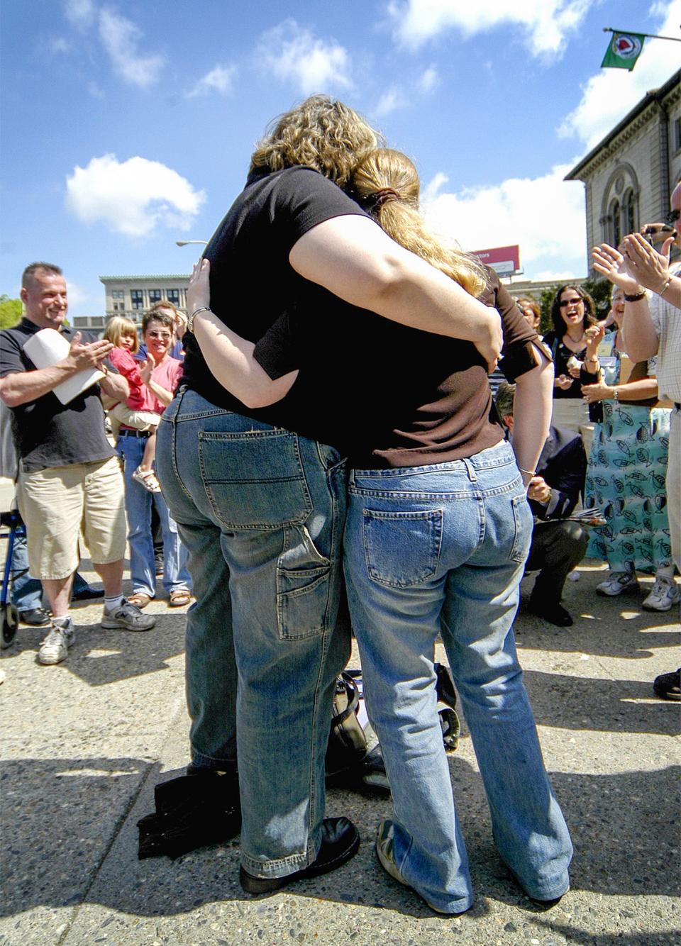 Donna Lockington and Kaitlyn Shusas, both of Worcester, embrace following their marriage ceremony in front of City Hall May 17, 2004. According to Steve Pratt, their justice of the peace, Lockington and Shusas were the first gay couple to officially marry in Worcester.