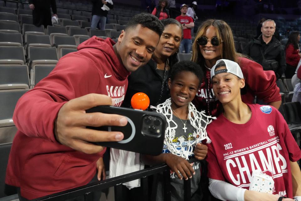 Denver Broncos quarterback Russell Wilson poses for a selfie with his sister, Stanford basketball player Anna Wilson, and his wife Ciara after the Pac-12 Tournament championship game. He should be on hand for Sunday's Elite Eight matchup between Texas and Stanford.