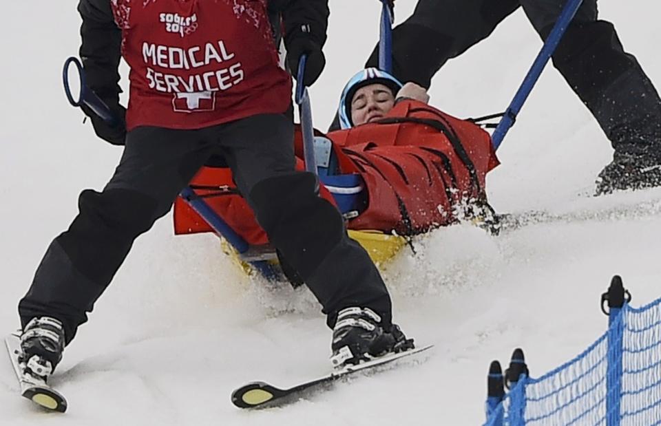 Germany's Woerner is carried off course by medical staff following a fall during the women's freestyle skiing skicross quarter-finals at the 2014 Sochi Winter Olympic Games