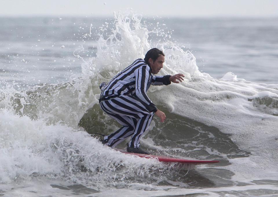 A participant surfs during the third annual Rockaway Halloween surf competition at Rockaway Beach in the Queens borough of New York