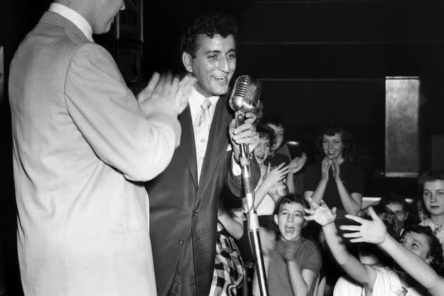 Hulton Archive/Getty Tony Bennett performing on stage at a high school in Cleveland, Ohio circa 1952