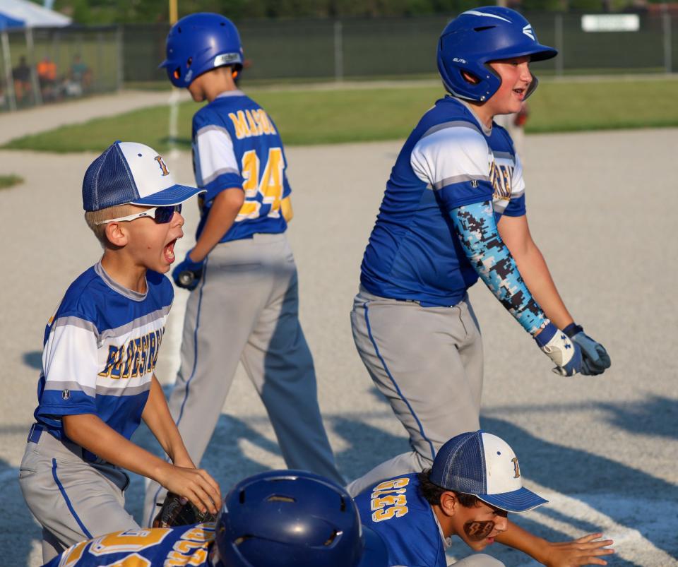 Ida players celebrate a home run by Brody Lehr in the finals of the 63rd annual Monroe County Fair Baseball Tournament Wednesday. Ida won the title with a 7-5 win over Bedford Elite.