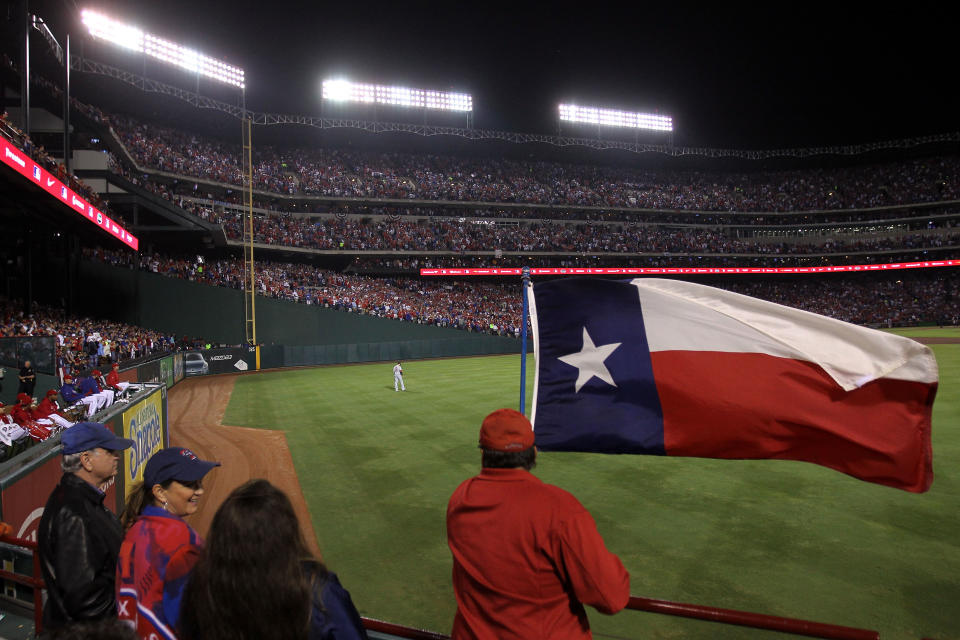 ARLINGTON, TX - OCTOBER 23: A Texas Rangers fan waves a flag during Game Four of the MLB World Series against the St. Louis Cardinals at Rangers Ballpark in Arlington on October 23, 2011 in Arlington, Texas. (Photo by Ezra Shaw/Getty Images)