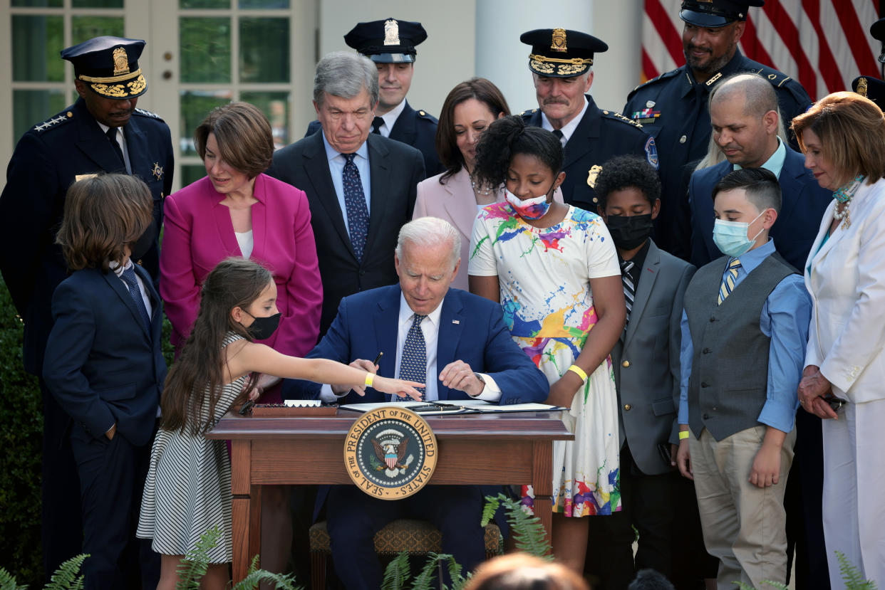 Joe Biden with lawmakers and members of law enforcement and their families