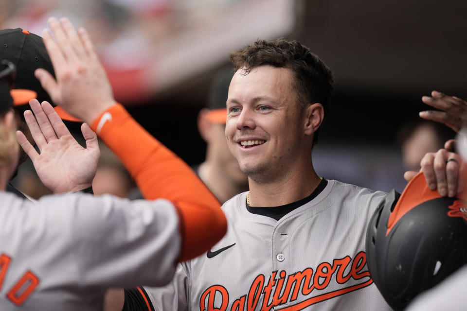 Baltimore Orioles' Ryan Mountcastle celebrates in the dugout after scoring on a single hit by teammate Anthony Santander in the first inning of a baseball game against the Cincinnati Reds, Sunday, May 5, 2024, in Cincinnati. (AP Photo/Carolyn Kaster)