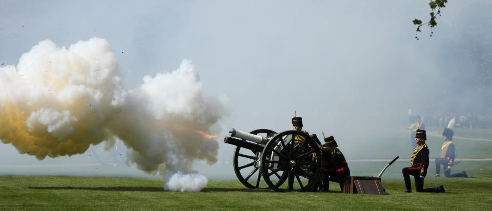 FILE - Members of the King's Troop Royal Artillery fire a Royal Salute of 42 guns in Hyde Park to celebrate Britain's Queen Elizabeth II's 96th birthday in Hyde Park, London, Thursday, April 21, 2022. Britain is getting ready for a party featuring mounted troops, solemn prayers — and a pack of dancing mechanical corgis. The nation will celebrate Queen Elizabeth II’s 70 years on the throne this week with four days of pomp and pageantry in central London. (AP Photo/Alastair Grant, File)