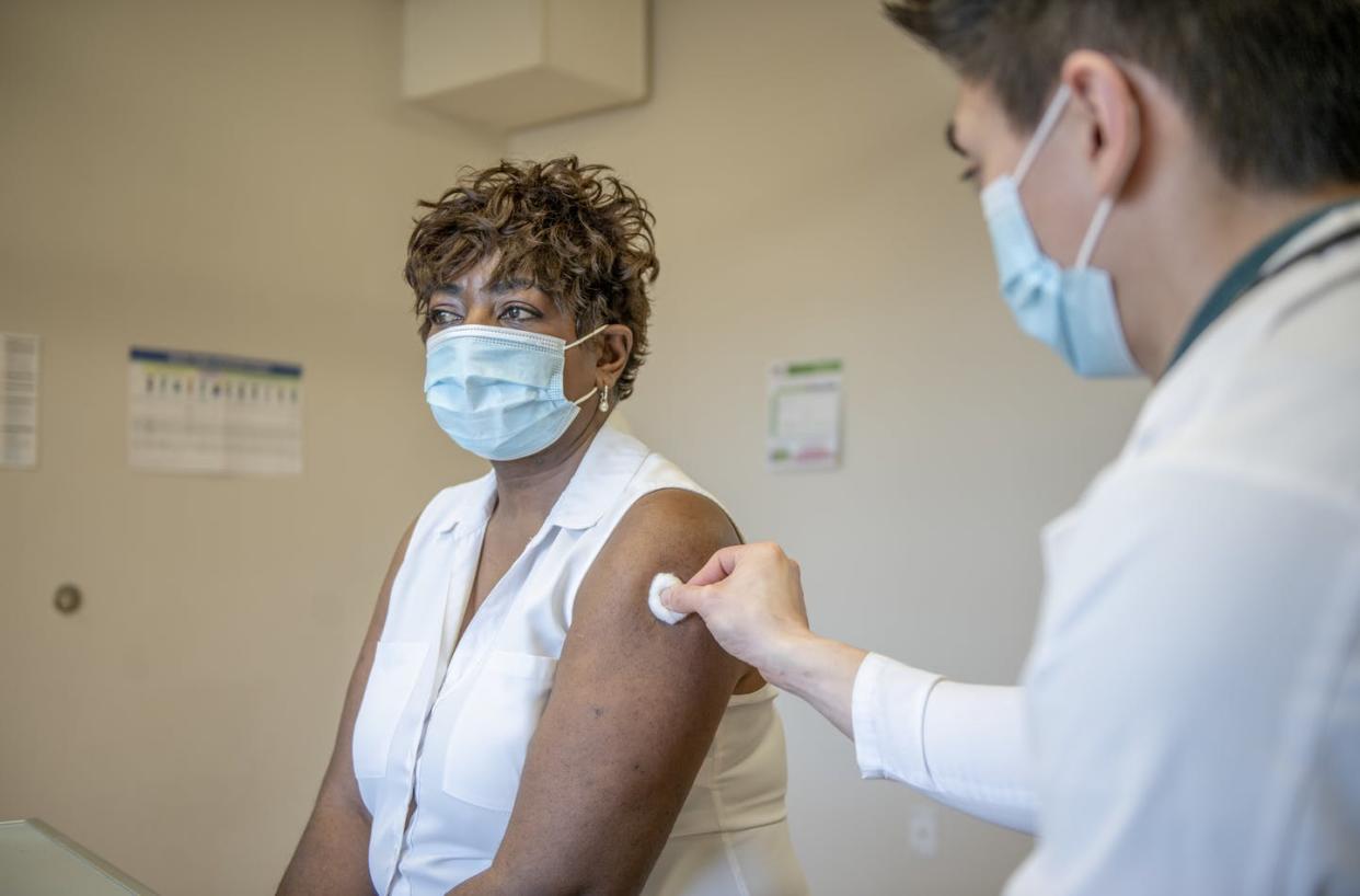 <span class="caption">With a COVID-19 booster shot, vaccine effectiveness against hospitalization goes up to 90%. </span> <span class="attribution"><a class="link " href="https://www.gettyimages.com/detail/photo/woman-gets-a-booster-vaccine-royalty-free-image/1362422474?adppopup=true" rel="nofollow noopener" target="_blank" data-ylk="slk:FatCamera/E+ via Getty Images;elm:context_link;itc:0;sec:content-canvas">FatCamera/E+ via Getty Images</a></span>