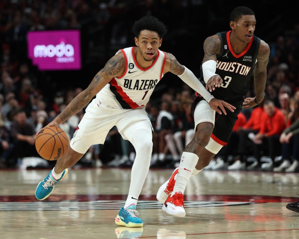 Portland Trail Blazers guard Anfernee Simons, left, drives past the defense of Houston Rockets guard Kevin Porter Jr., right, during the second half of an NBA basketball game in Portland, Ore., Friday, Oct. 28, 2022. (AP Photo/Steve Dipaola)